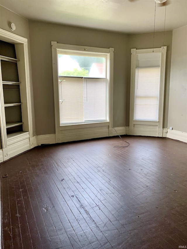 spare room with dark hardwood / wood-style floors