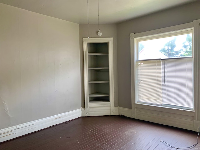 spare room with dark hardwood / wood-style floors