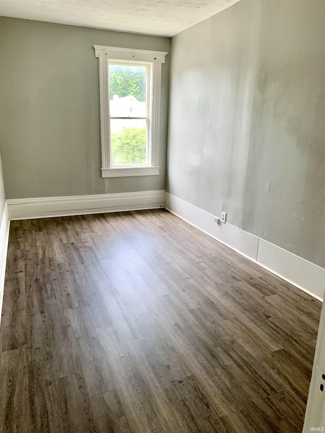 spare room featuring hardwood / wood-style flooring and a textured ceiling