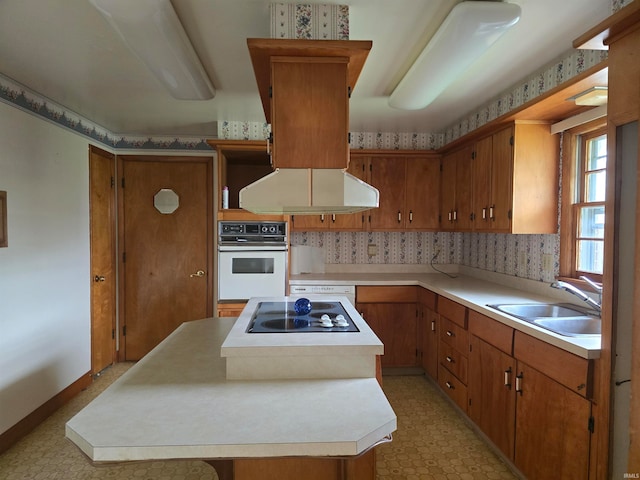 kitchen with light tile patterned floors, a center island, white oven, sink, and black electric stovetop