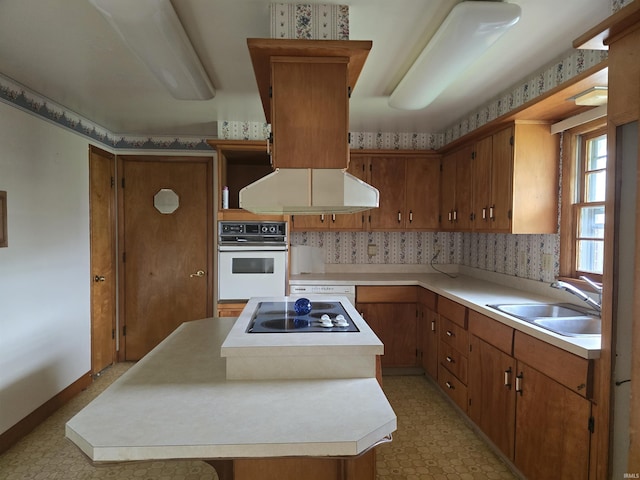 kitchen with sink, range hood, oven, and black electric stovetop