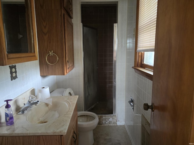 bathroom featuring tile walls, tile patterned flooring, vanity, a shower with shower door, and toilet