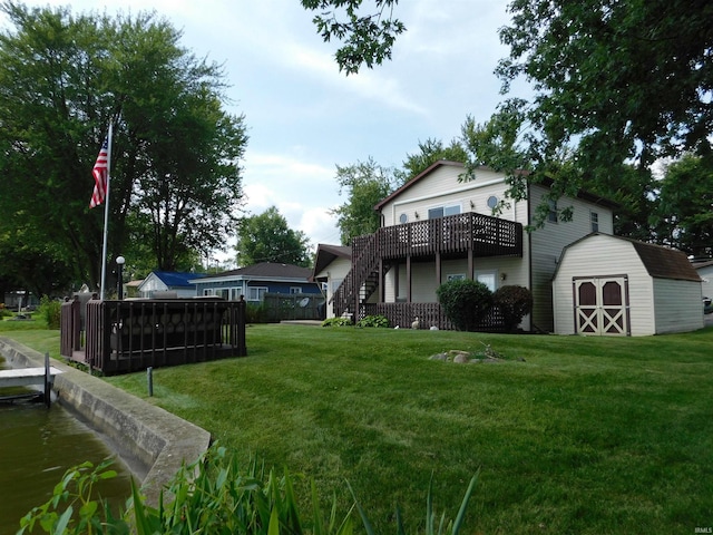 view of yard featuring a deck and a storage unit