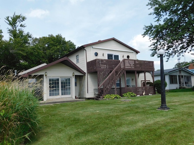 back of property with a deck and a yard