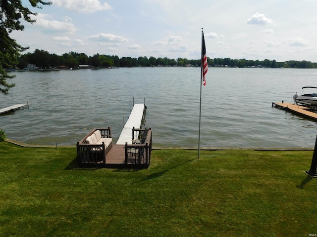 view of dock featuring a water view and a lawn