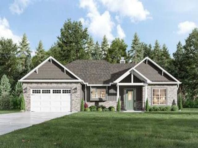 view of front facade featuring a front yard and a garage