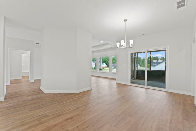 unfurnished room with light hardwood / wood-style floors and a chandelier