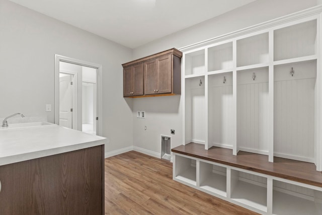 mudroom with sink and light hardwood / wood-style flooring