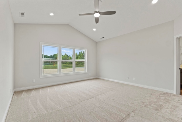 unfurnished room with lofted ceiling, light carpet, and ceiling fan