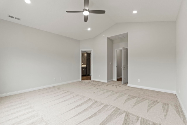 unfurnished bedroom with ceiling fan, light colored carpet, and lofted ceiling