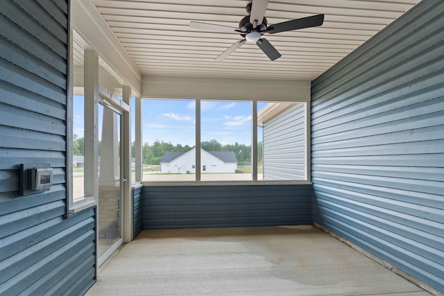 unfurnished sunroom featuring ceiling fan and wooden ceiling