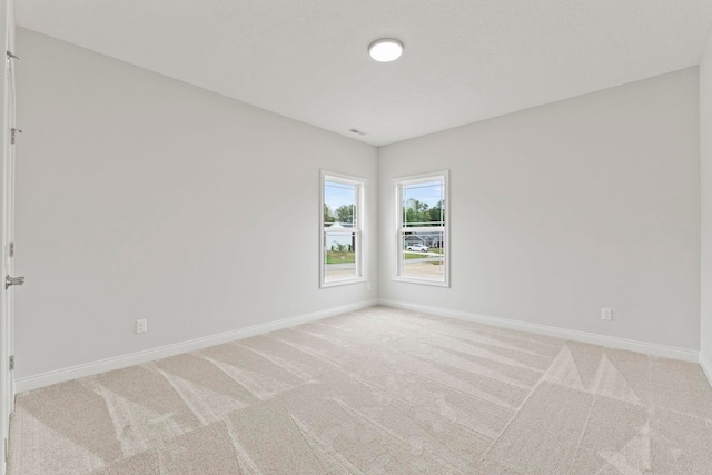 empty room with light colored carpet