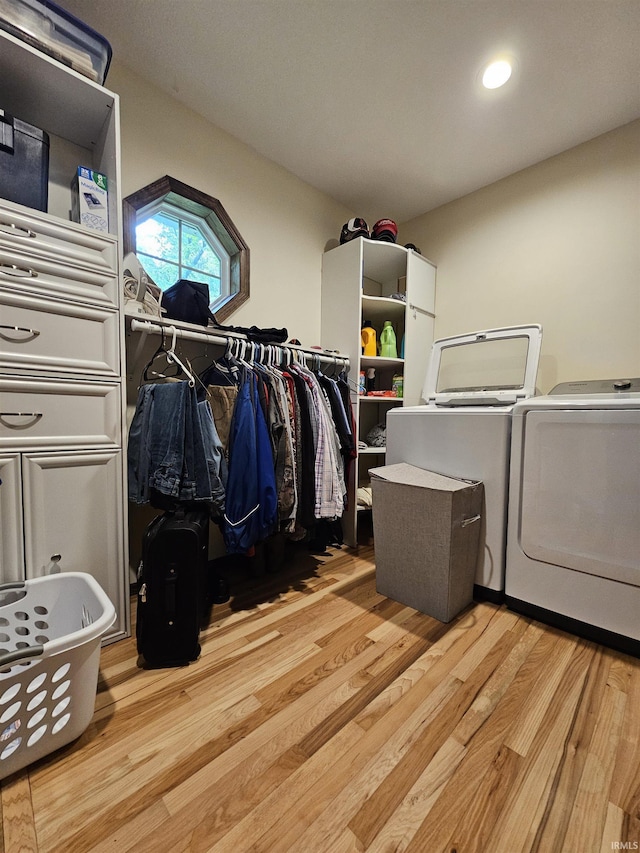 washroom with washer and dryer and light hardwood / wood-style flooring