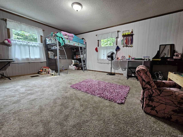 bedroom featuring crown molding, carpet flooring, and a textured ceiling