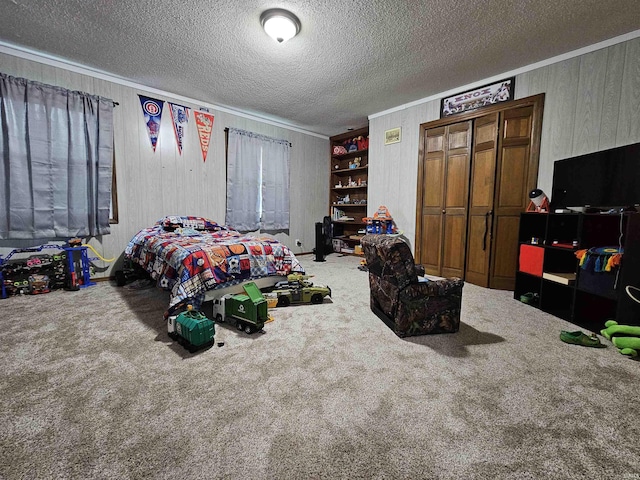 carpeted bedroom featuring ornamental molding and a textured ceiling