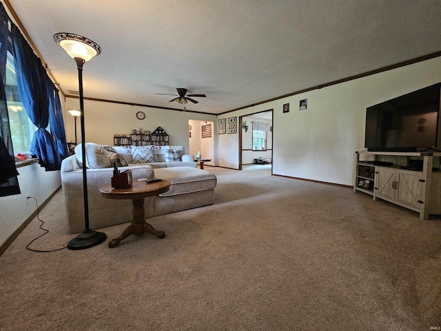 carpeted living room with crown molding, a textured ceiling, and ceiling fan