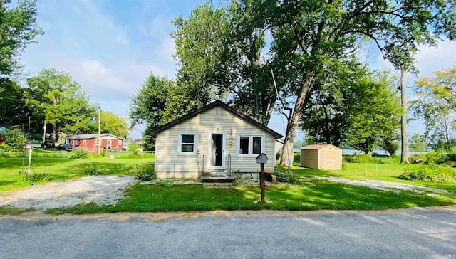 view of front facade with a shed and a front yard