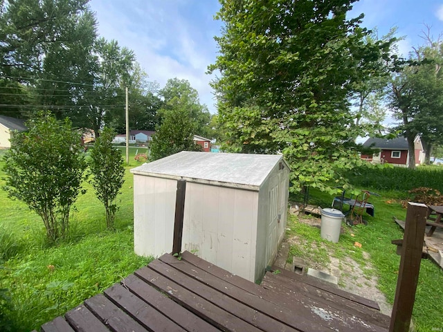 deck featuring a yard and a shed