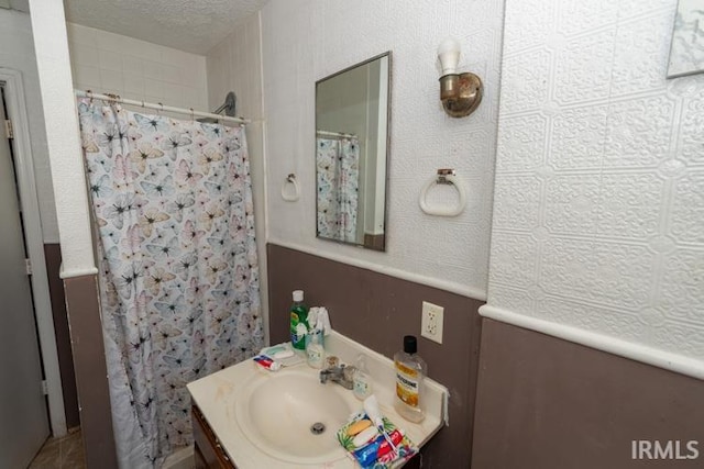 bathroom with vanity and a textured ceiling