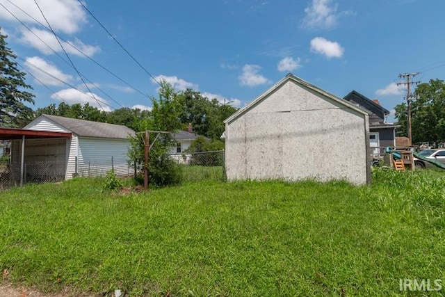 exterior space with an outbuilding and a lawn