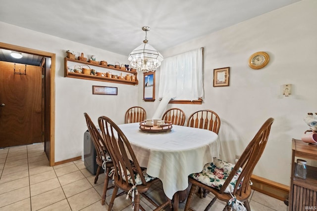 dining room featuring light tile patterned flooring and a chandelier