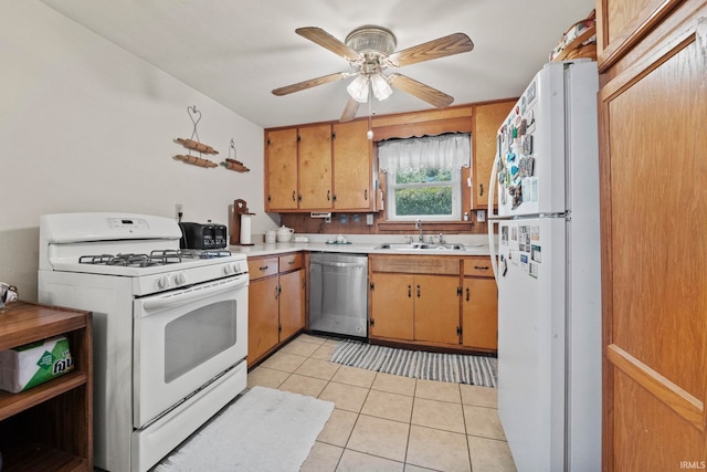 kitchen featuring sink, white appliances, light tile patterned floors, and ceiling fan