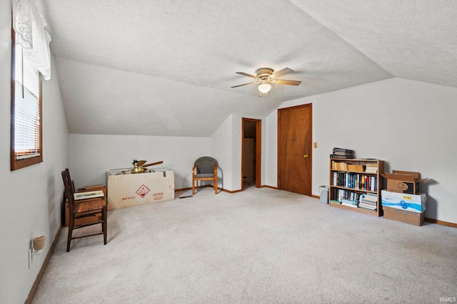 bonus room with lofted ceiling, ceiling fan, carpet floors, and a textured ceiling