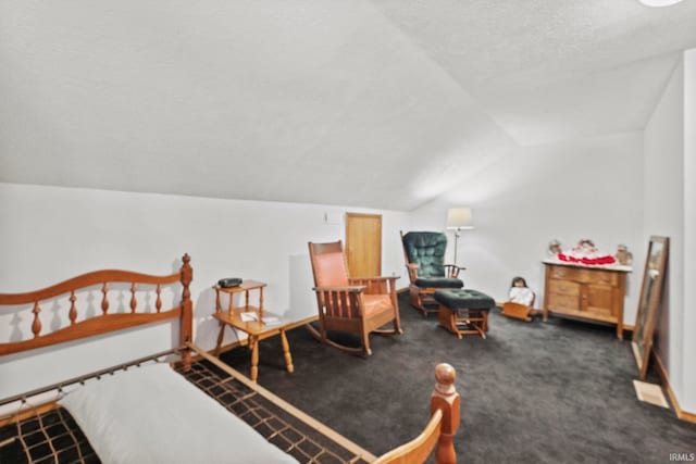 carpeted bedroom with vaulted ceiling and a textured ceiling