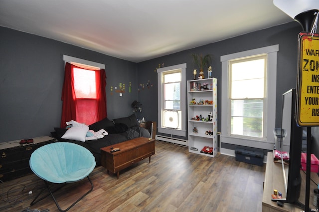 office area featuring a baseboard heating unit and hardwood / wood-style flooring