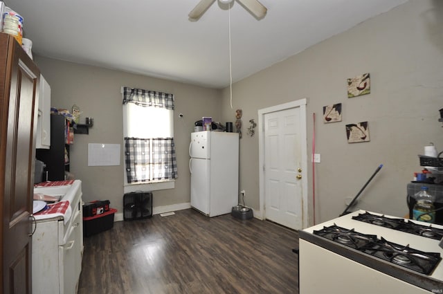 kitchen with white refrigerator, dark hardwood / wood-style floors, ceiling fan, and range with gas cooktop