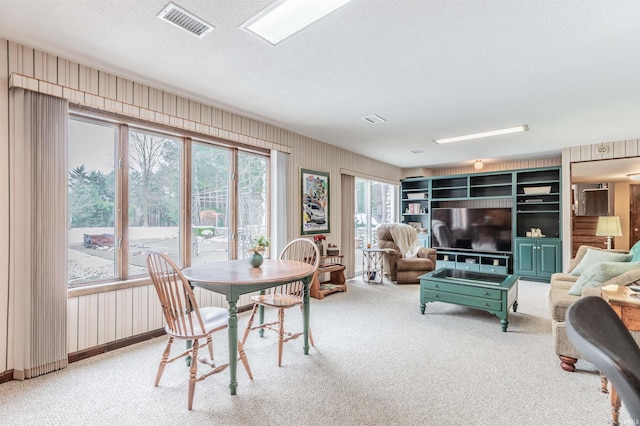 dining room with a textured ceiling and carpet flooring