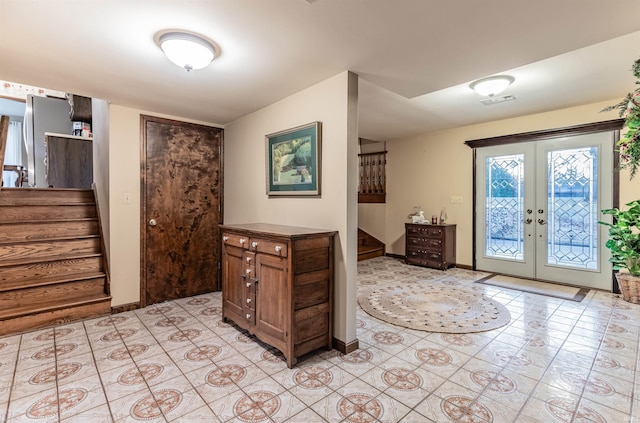 entrance foyer with light tile patterned floors and french doors