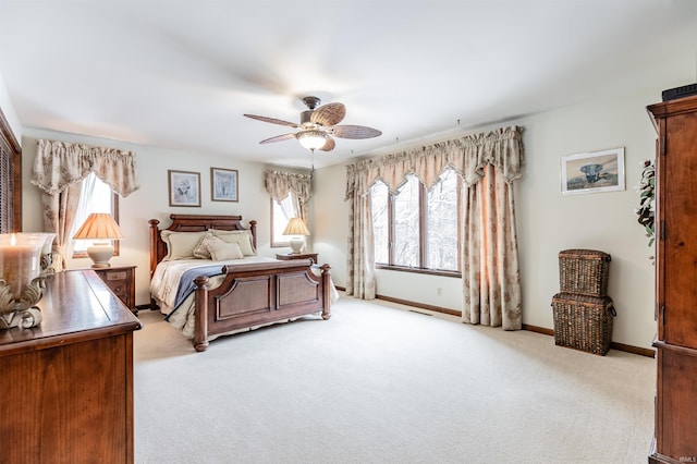 bedroom featuring light colored carpet and ceiling fan