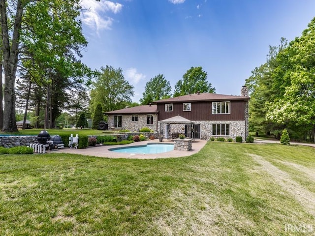 rear view of house featuring a gazebo, a patio area, and a lawn