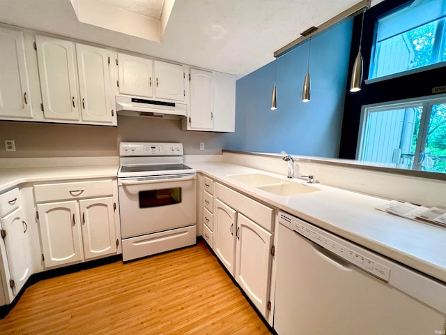 kitchen featuring white appliances, light hardwood / wood-style floors, white cabinetry, and sink