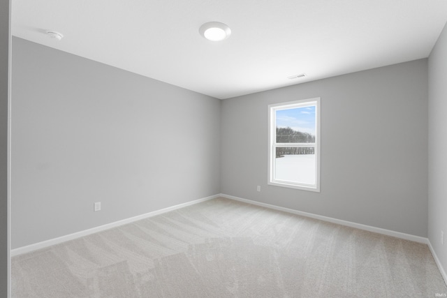 unfurnished room featuring light colored carpet