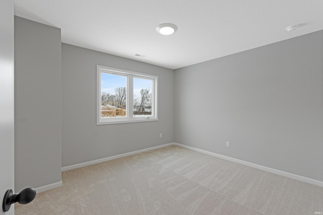 unfurnished room featuring light colored carpet