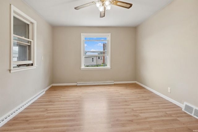 unfurnished room with visible vents, a ceiling fan, baseboard heating, light wood-type flooring, and a baseboard heating unit