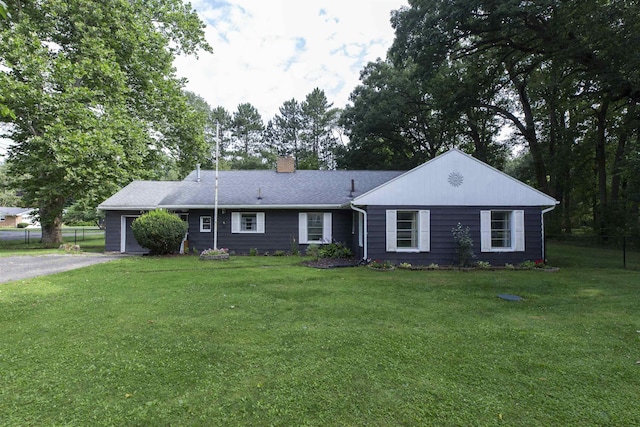 ranch-style home featuring a garage and a front yard