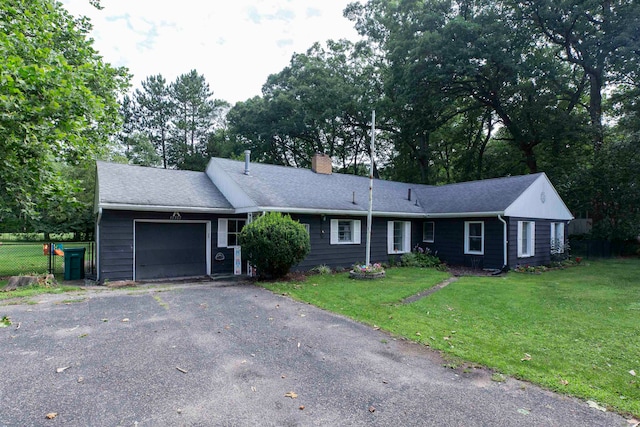 single story home featuring a garage and a front lawn