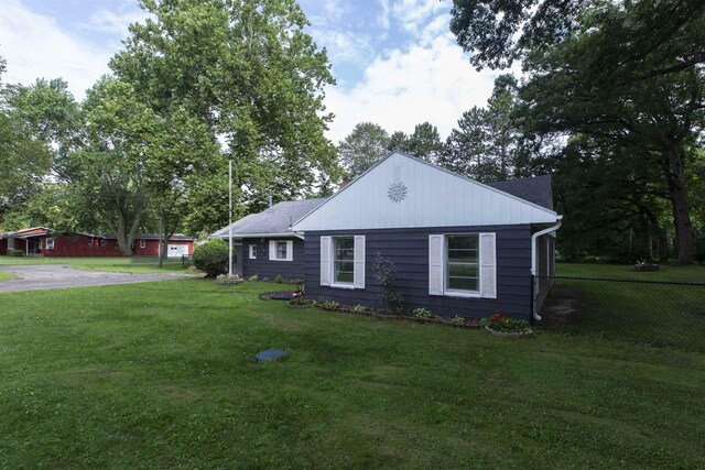 view of side of home with a yard