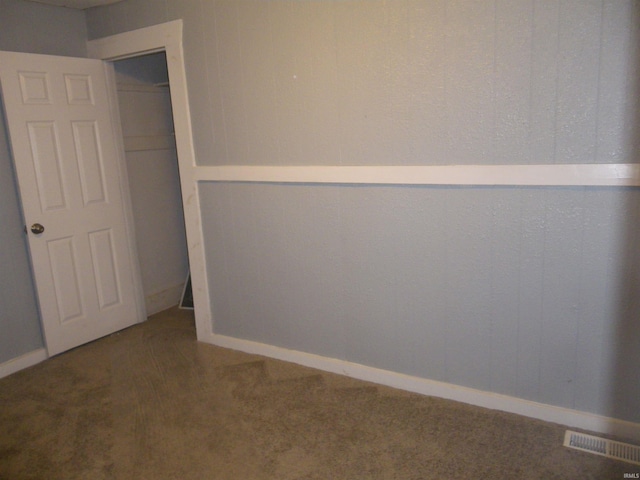 unfurnished bedroom featuring carpet and a closet