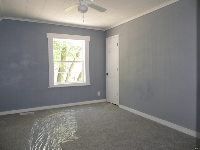 carpeted spare room with ornamental molding and ceiling fan