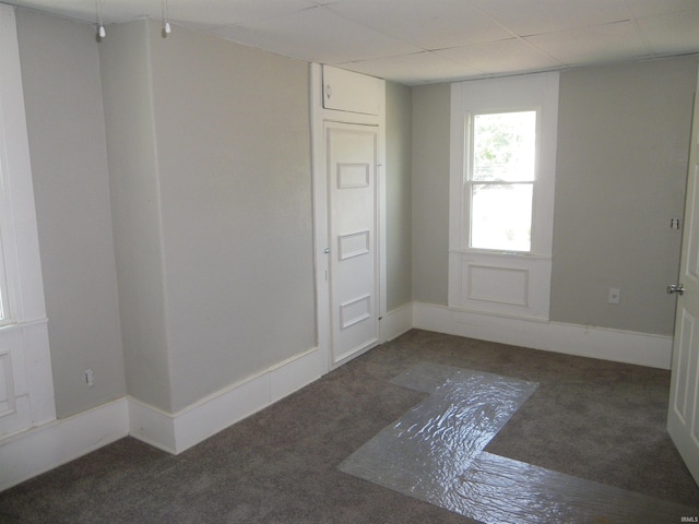 empty room with dark colored carpet