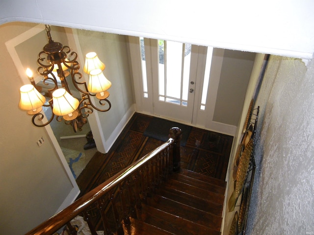 stairs featuring an inviting chandelier