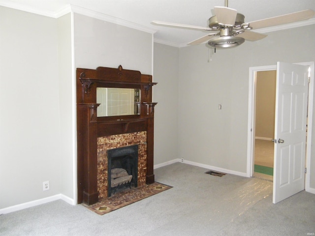 carpeted living room featuring a fireplace, ceiling fan, and crown molding