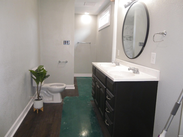 bathroom with hardwood / wood-style flooring, vanity, and toilet