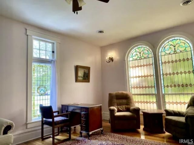 sitting room featuring hardwood / wood-style flooring and ceiling fan