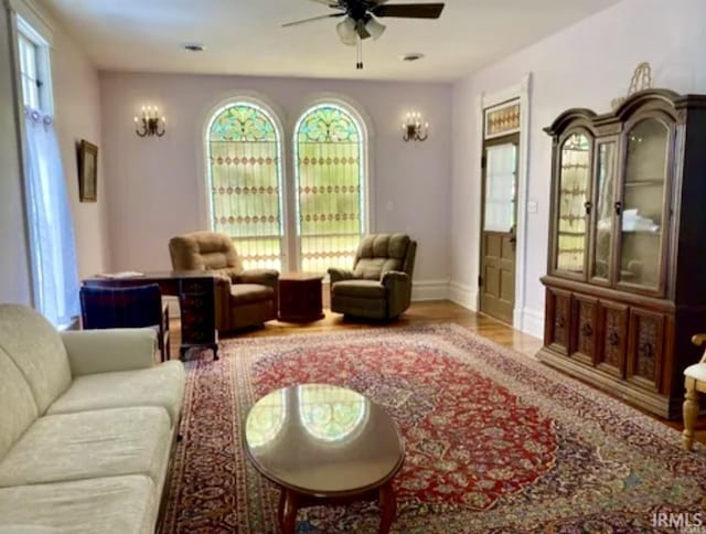 living area featuring hardwood / wood-style flooring and ceiling fan