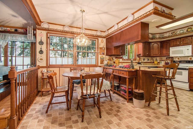 dining space with an inviting chandelier and ornamental molding